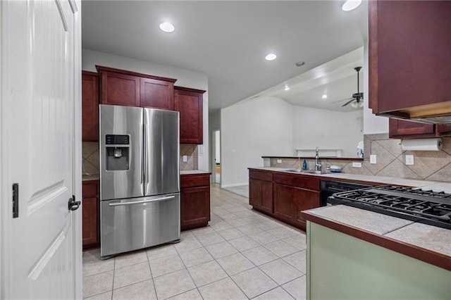 kitchen featuring decorative backsplash, stainless steel refrigerator with ice dispenser, ceiling fan, sink, and light tile patterned floors