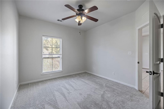 unfurnished room with ceiling fan and light colored carpet