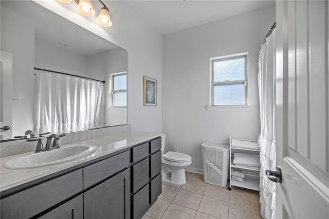 bathroom with tile patterned flooring, vanity, and toilet