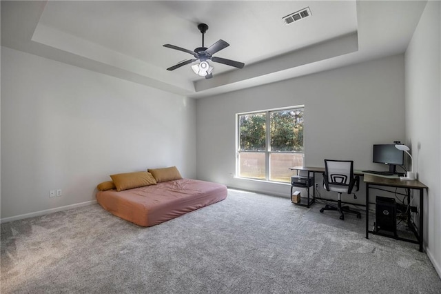 sitting room featuring carpet floors, a tray ceiling, and ceiling fan