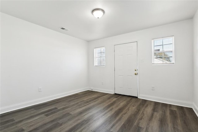 spare room with dark hardwood / wood-style floors