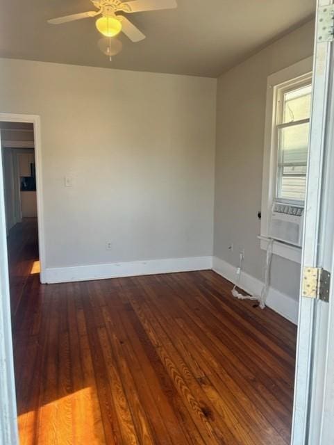 spare room featuring ceiling fan and dark wood-type flooring