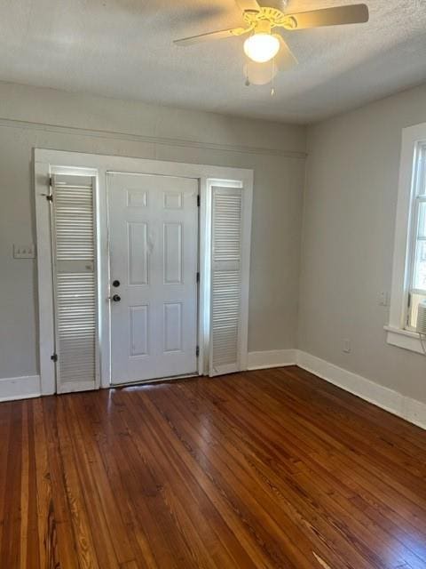 foyer featuring ceiling fan and dark wood-type flooring