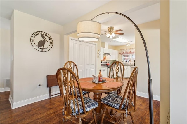 dining room featuring ceiling fan and dark hardwood / wood-style floors