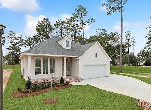 view of front of property with a garage and a front yard