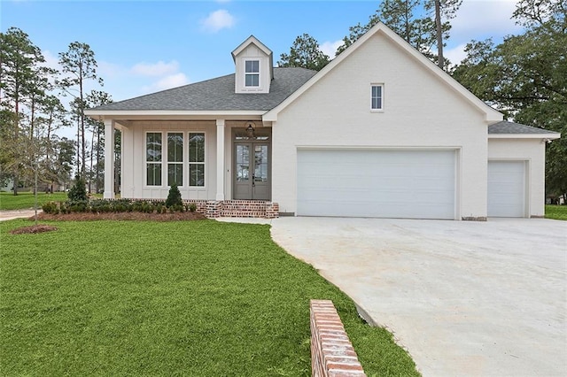 view of front facade with a garage, a front lawn, and french doors