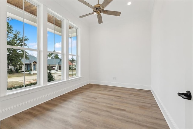 spare room with hardwood / wood-style flooring and ceiling fan