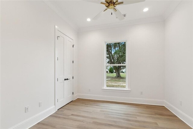 spare room featuring ceiling fan, light hardwood / wood-style floors, and crown molding