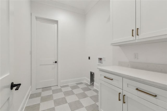 laundry room featuring crown molding, hookup for a washing machine, electric dryer hookup, and cabinets