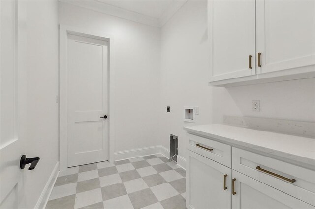 laundry room featuring crown molding, hookup for a washing machine, electric dryer hookup, and cabinets