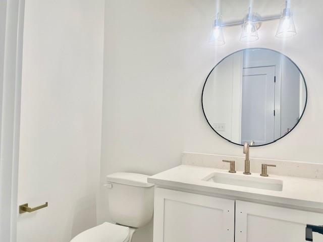 bathroom featuring toilet and vanity