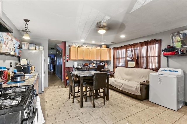 1910B Charbonnet St, New Orleans, LA 70117 - kitchen featuring washer / dryer, light brown cabinets, light countertops, ceiling fan, and black range with gas stovetop