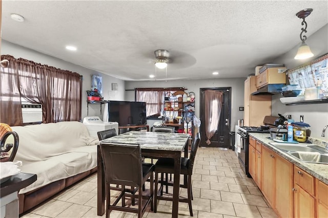 1910B Charbonnet St, New Orleans, LA 70117 - kitchen featuring black range with gas cooktop, open floor plan, a ceiling fan, light tile patterned floors, and under cabinet range hood