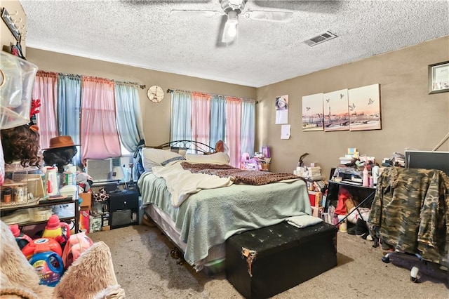 bedroom with multiple windows, ceiling fan, and carpet