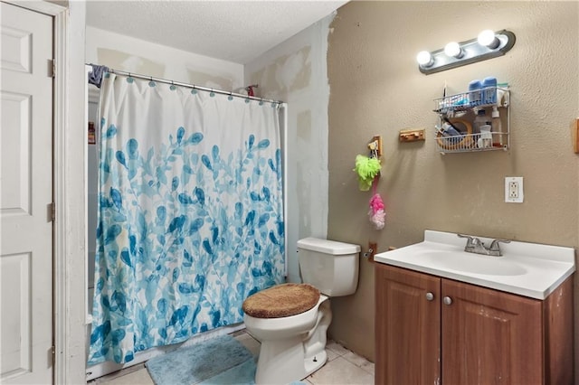 bathroom with vanity, a shower with curtain, tile patterned flooring, toilet, and a textured ceiling