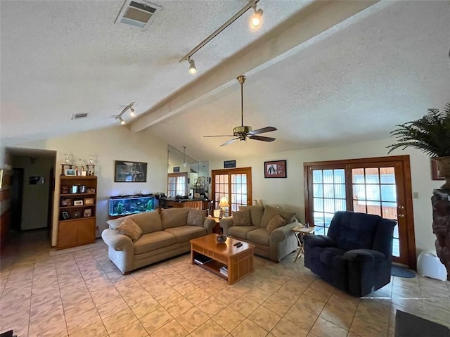 living room featuring ceiling fan, french doors, lofted ceiling with beams, track lighting, and a textured ceiling