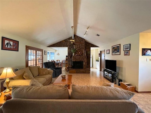 living room with a fireplace, light tile patterned flooring, and lofted ceiling with beams