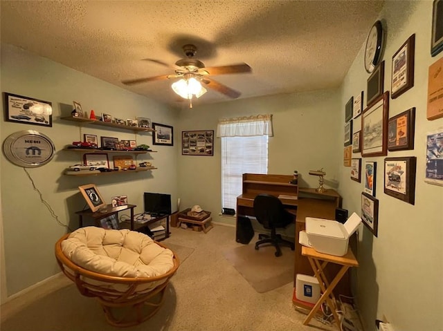 carpeted office with ceiling fan and a textured ceiling