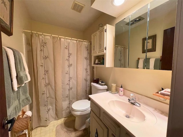 bathroom with curtained shower, vanity, and toilet