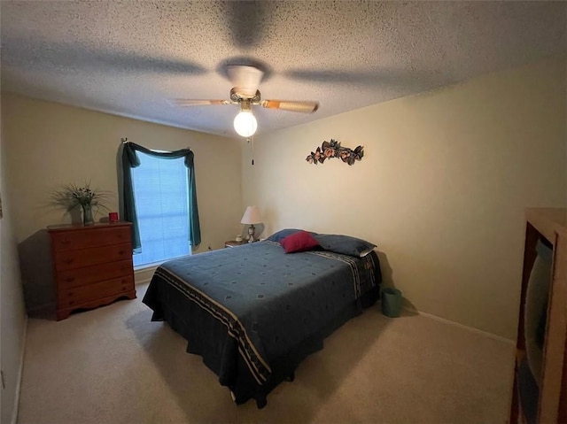 carpeted bedroom with a textured ceiling and ceiling fan