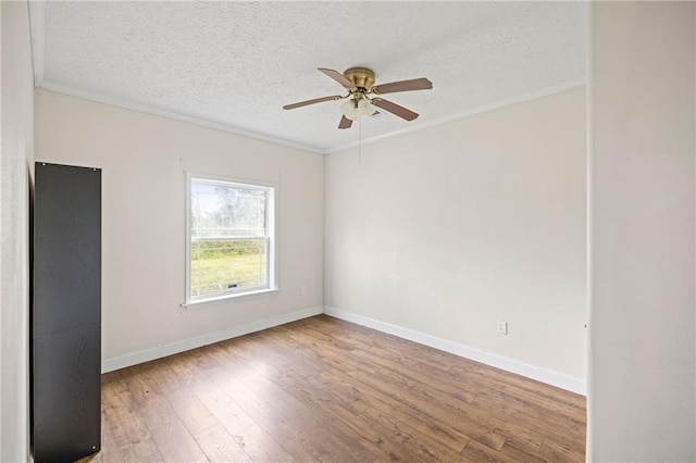 unfurnished room featuring hardwood / wood-style floors, ceiling fan, ornamental molding, and a textured ceiling