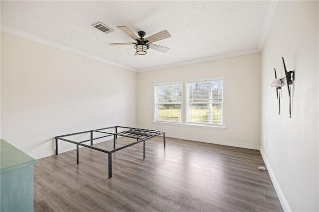 game room featuring a textured ceiling, dark hardwood / wood-style flooring, ceiling fan, and ornamental molding