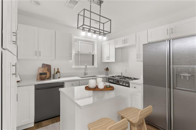 kitchen featuring sink, stainless steel refrigerator with ice dispenser, black dishwasher, decorative light fixtures, and white cabinetry