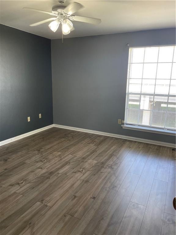 spare room featuring ceiling fan and dark wood-type flooring