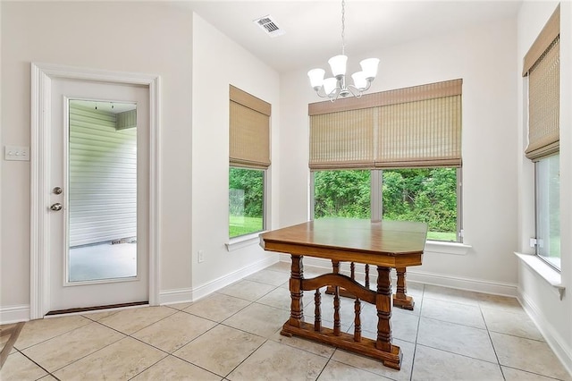 tiled dining area with a notable chandelier