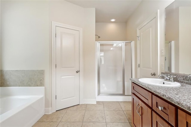 bathroom with shower with separate bathtub, vanity, and tile patterned floors