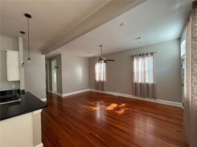 kitchen featuring white cabinets, ceiling fan, dark wood-type flooring, and hanging light fixtures