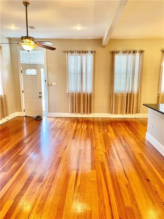 entryway featuring hardwood / wood-style floors, ceiling fan, and beam ceiling