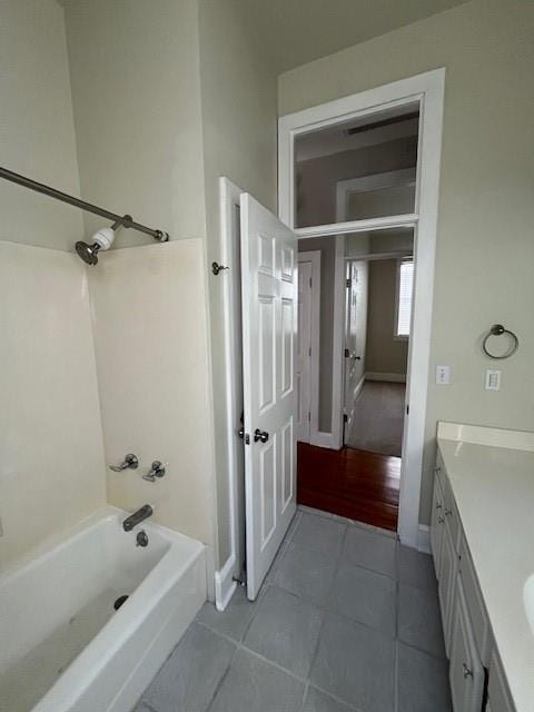 bathroom with tile patterned floors, vanity, and  shower combination