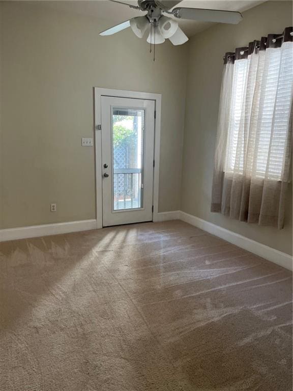 entryway featuring ceiling fan and carpet floors