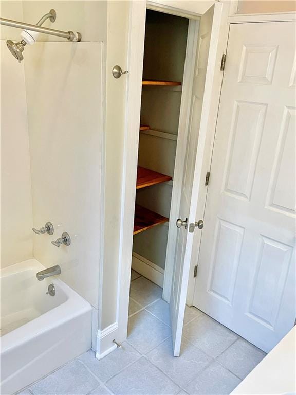 bathroom with shower / bath combination and tile patterned floors