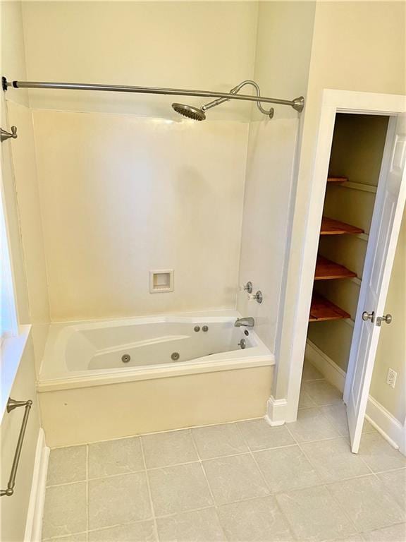 bathroom featuring tile patterned floors and washtub / shower combination