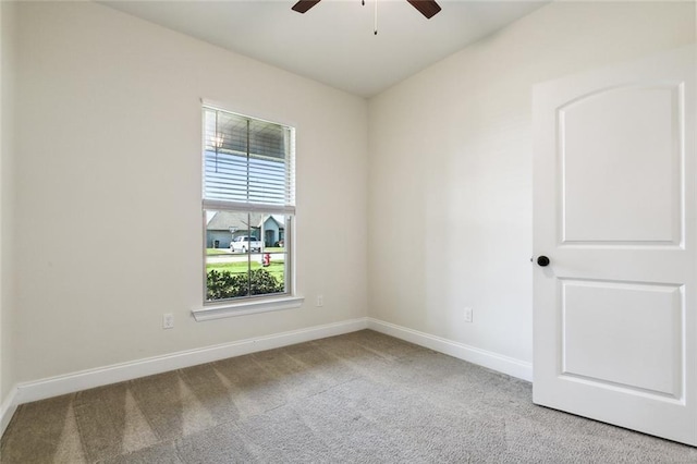 carpeted spare room with ceiling fan