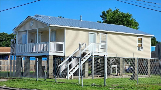 back of house featuring a lawn and a porch