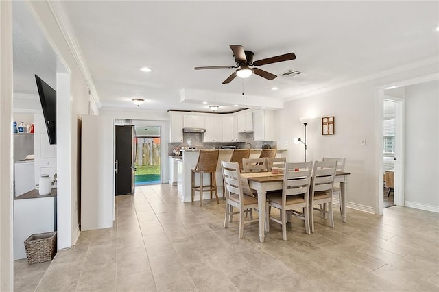 dining room featuring ceiling fan and ornamental molding