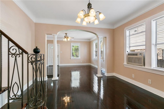 foyer featuring ornate columns, ceiling fan with notable chandelier, dark hardwood / wood-style floors, and ornamental molding