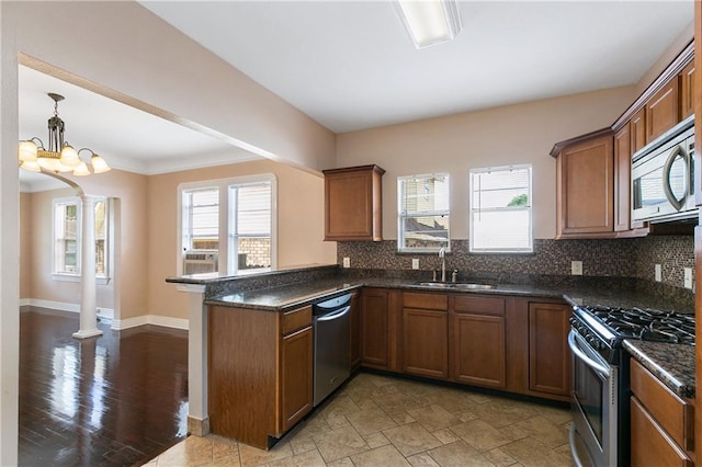 kitchen featuring backsplash, plenty of natural light, sink, and stainless steel appliances