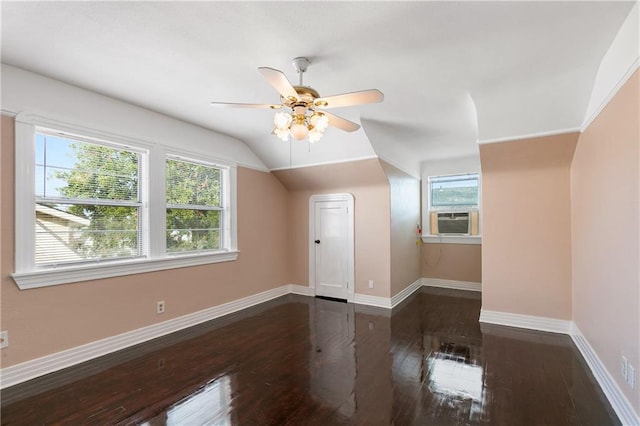 additional living space featuring a healthy amount of sunlight, ceiling fan, dark wood-type flooring, and lofted ceiling