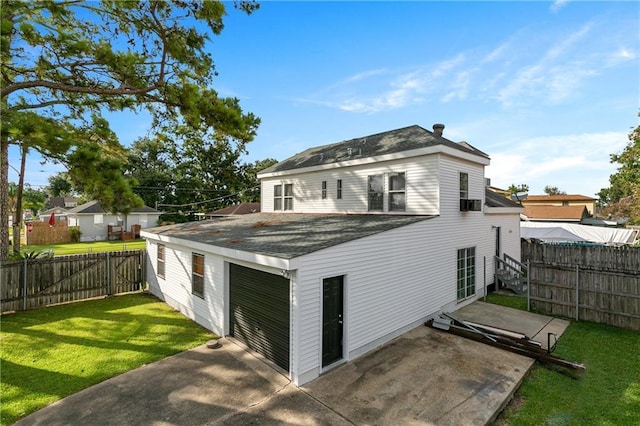 rear view of house featuring a yard and a patio