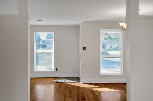 entryway featuring an inviting chandelier and light wood-type flooring