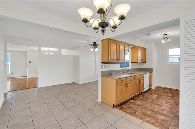 kitchen with dishwasher, light tile patterned floors, ceiling fan with notable chandelier, and sink