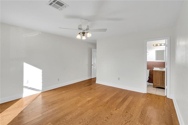 empty room featuring ceiling fan and light wood-type flooring