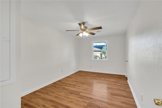 spare room with ceiling fan and light wood-type flooring