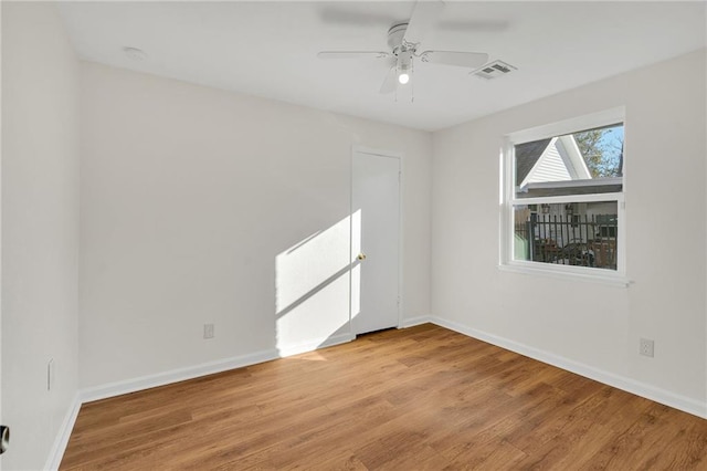 empty room with ceiling fan and light hardwood / wood-style floors