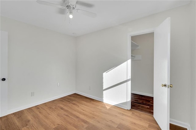 unfurnished room featuring ceiling fan and light wood-type flooring