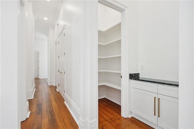 hallway with hardwood / wood-style floors